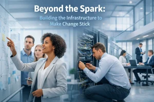 A woman draws on a whiteboard with diagrams, while a man works on server equipment. Other professionals collaborate in a modern office. Text reads: Beyond the Spark: Building the Infrastructure to Make Change Stick.